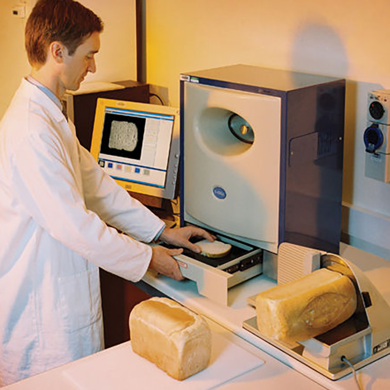 Scientist assessing the food structure of a slice of bread