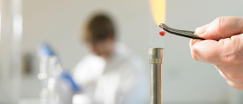 Close up of ingredient being heated by a Bunsen burner in laboratory