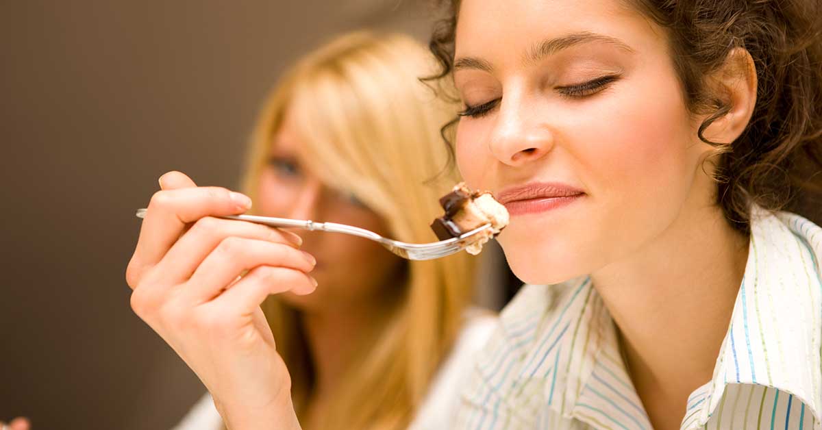 Woman eating dessert off fork