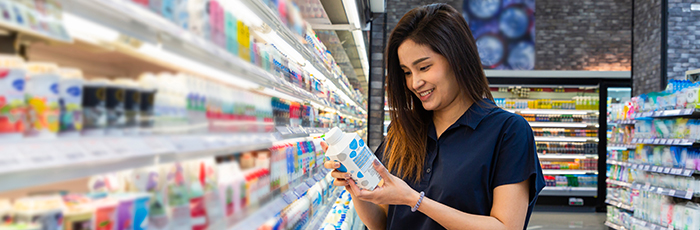 Consumer reading food label in supermarket