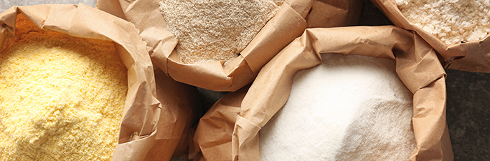 Selection of different flour types in brown sacks