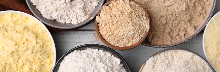 Selection of different flours in bowls on a table